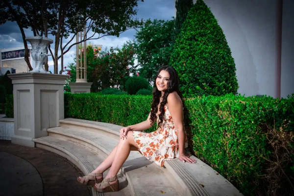 Las Vegas Strip senior portraits senior girl in a floral dress sitting outdoors at Caesars Palace