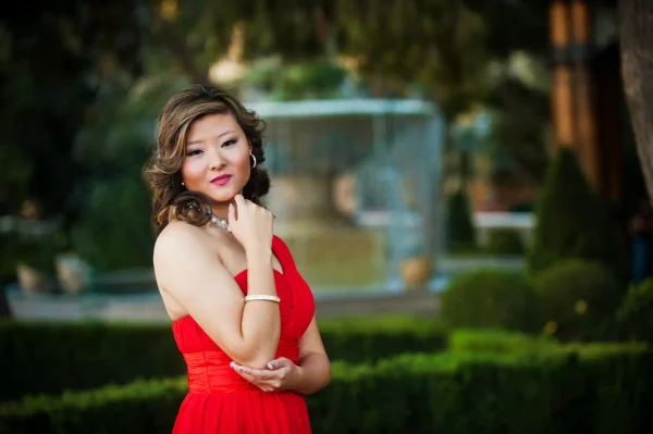 Las Vegas Strip senior portraits girl in a red dress posing by fountains during an outdoor photo session