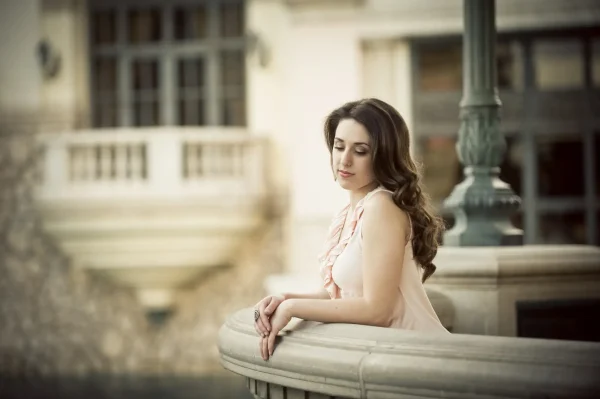 Las Vegas Strip senior portraits senior girl posing by a stone railing at Bellagio during an outdoor session