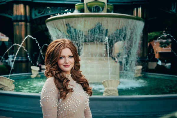 Las Vegas Strip senior portraits senior girl in a tan pearl top posing in front of the Bellagio fountains