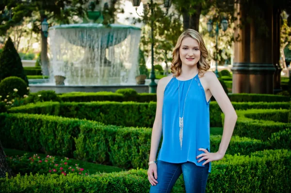 Las Vegas Strip senior portraits senior girl in a blue outfit posing in front of the Bellagio fountains