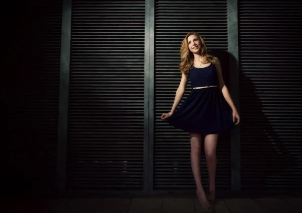 Las Vegas Strip senior portraits senior girl in a navy dress posing in front of dark shutter doors