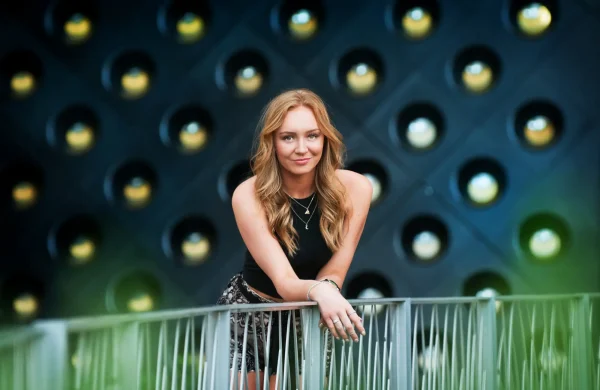 Las Vegas Strip senior portraits senior girl leaning on a railing with city lights in the background