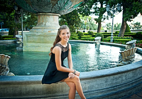 Las Vegas Strip senior portraits senior girl in a black dress sitting by the Bellagio fountain