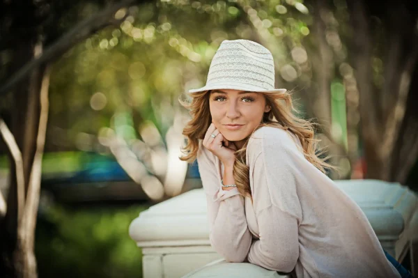 Las Vegas Strip senior portraits senior girl wearing a white fedora posing outdoors at Bellagio